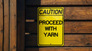 a caution sign posted on a wooden fence