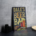 a sign that says dale's beer bar next to a plate of beer