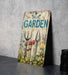 a garden sign sitting on top of a table