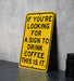 a yellow sign that says if you're looking for a sign to drink coffee