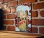 a picture of a beer sign on a brick wall