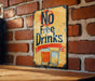 a no free drinks sign on a brick wall