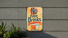 a no free drinks sign on the side of a building