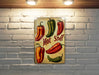 a painting of hot peppers on a brick wall