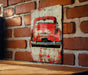 an old red car painted on a brick wall