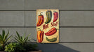a sign on the side of a building advertising hot peppers