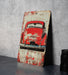 a picture of an old red car on a table