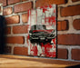 a painting of a car on a brick wall