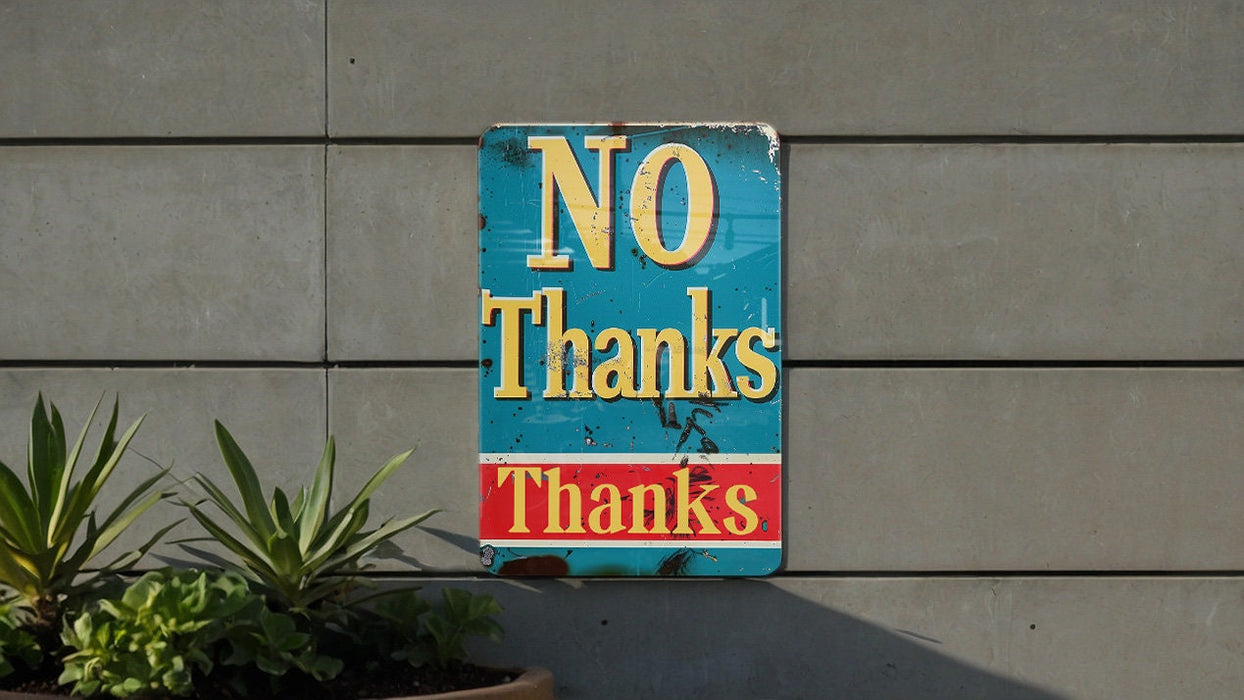 a no thanks sign on the side of a building