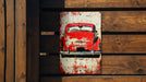 a red car painted on a wooden wall