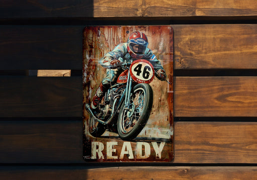 a painting of a motorcycle rider on a rusty sign