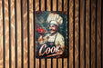 a sign on a wooden wall that says cook