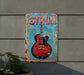 a red and blue guitar sign on a wall