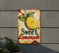a sign that says sweet lemonade hanging on the side of a building