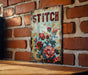a picture of some flowers on a brick wall