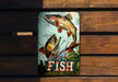a fish sign is hanging on a wooden wall