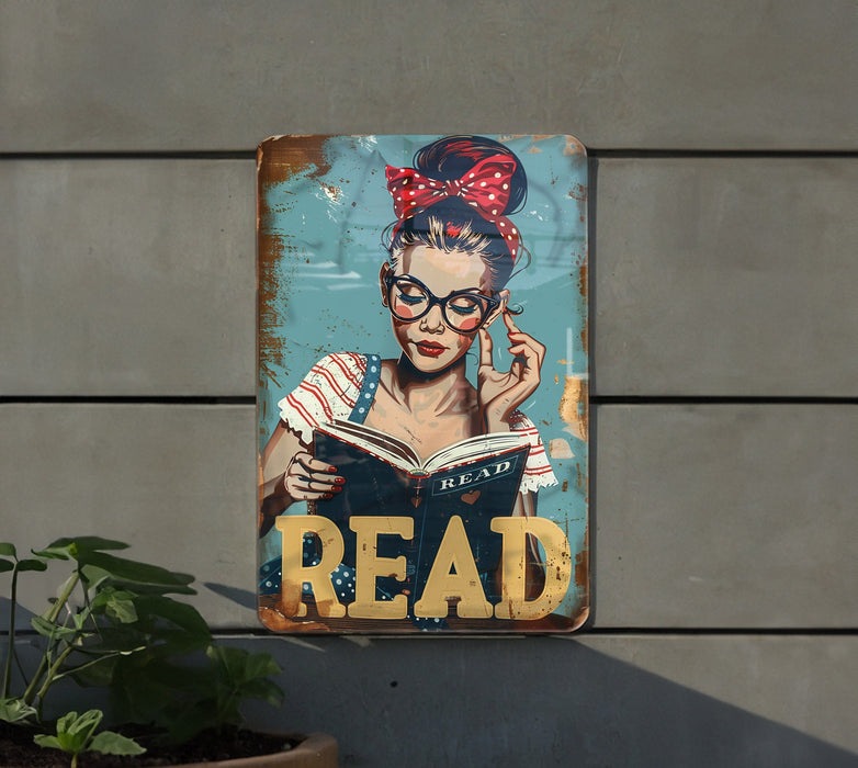 a metal sign with a woman reading a book