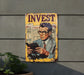 a sign on the side of a building that says invest