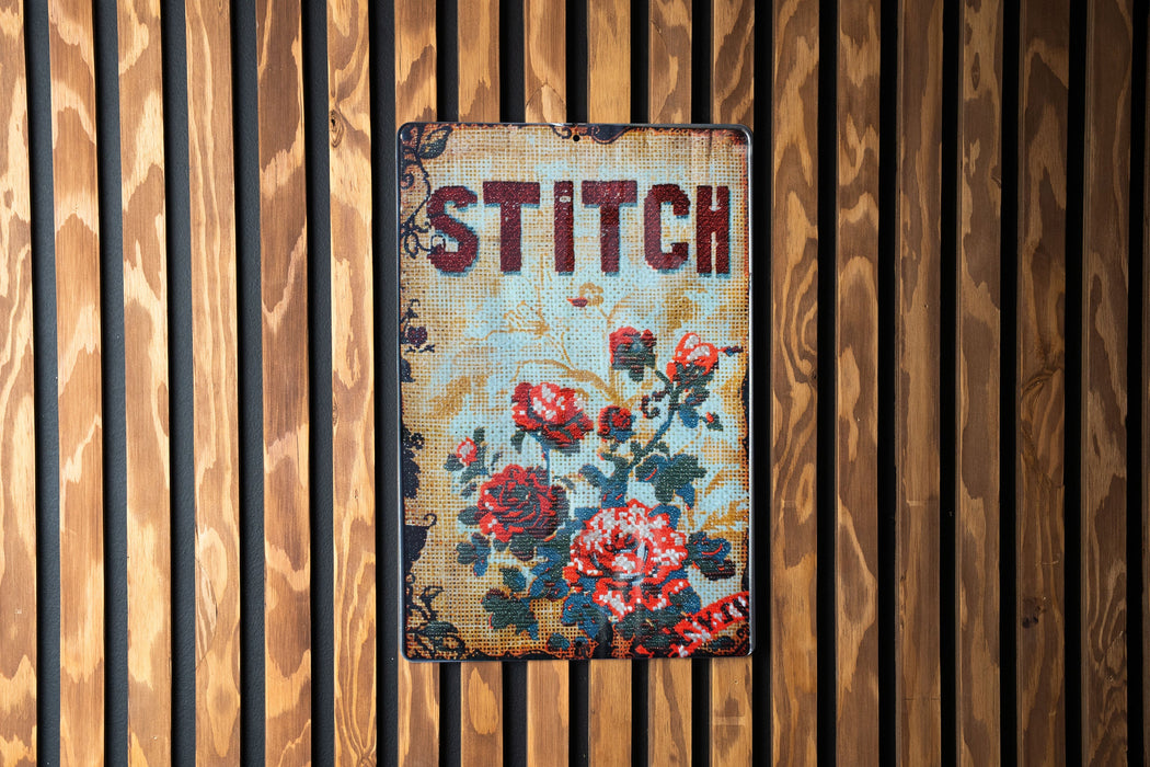a sign on a wooden wall that says stitch