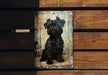 a black dog sitting on top of a wooden bench