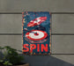 a sign that says spin on it next to a potted plant