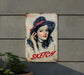 a painting of a woman with a hat on a wall