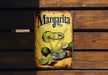 a metal sign with a margarita drink on it