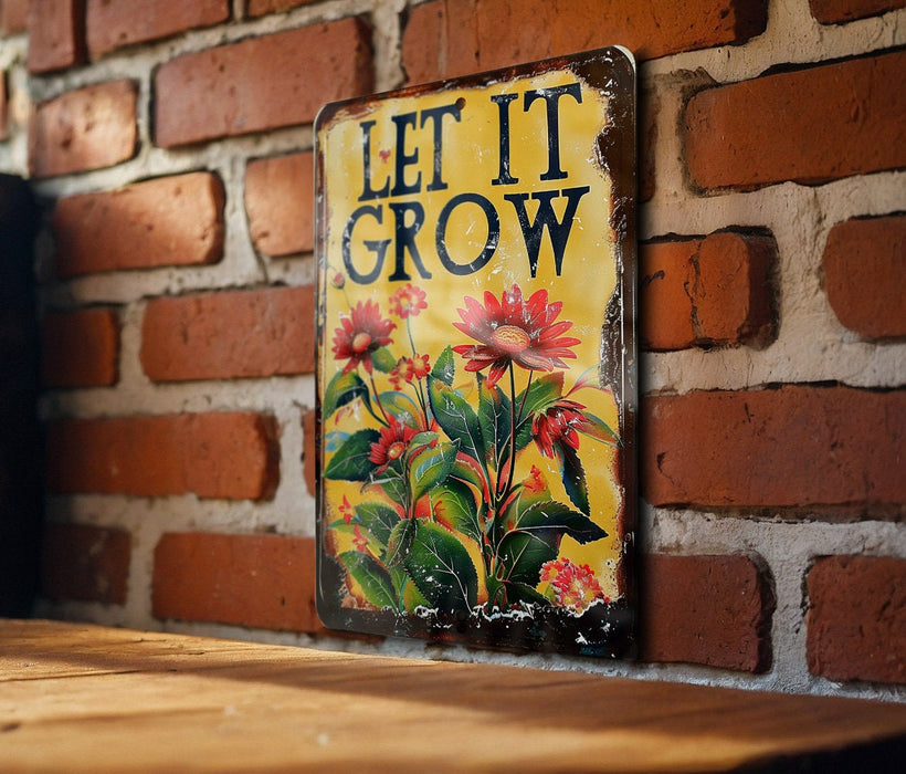 a sign that says let it grow on a brick wall