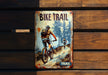 a sign on a wooden wall that says bike trail