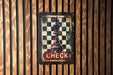 a metal sign with a chess piece on it