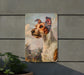 a picture of a dog is hanging on a wall