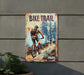 a sign on the side of a building that says bike trail