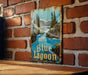 a blue lagoon sign on a brick wall