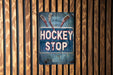 a sign on a wooden wall that says hockey stop