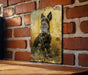 a picture of a dog is hanging on a brick wall