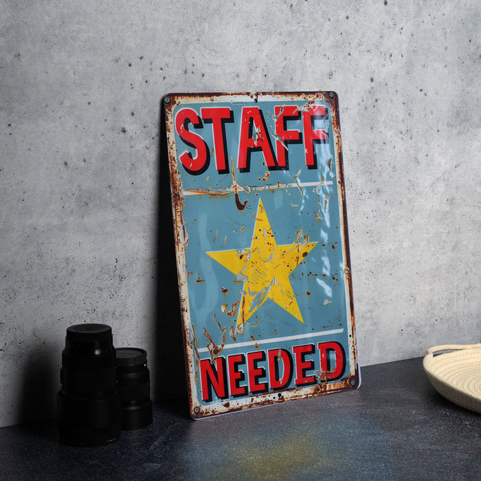 a sign that says staff needed on it
