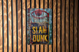 a sign that says slam dunk on a wooden wall