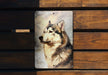 a picture of a dog on a metal plaque