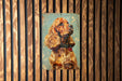 a painting of a dog on a wooden wall