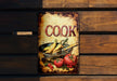 a sign on a wooden wall that says cook