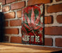 a picture of a marijuana leaf on a brick wall