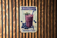 a blueberry smoothie sign hangs on a wooden wall