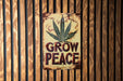 a sign on a wall that says grow peace