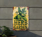 a sign that says herb garden next to a potted plant