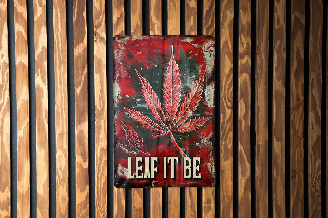 a sign that says leaf it be on a wooden wall