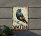 a bird is sitting on a branch of a watch sign