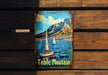 a table mountain sign hanging on a wooden wall