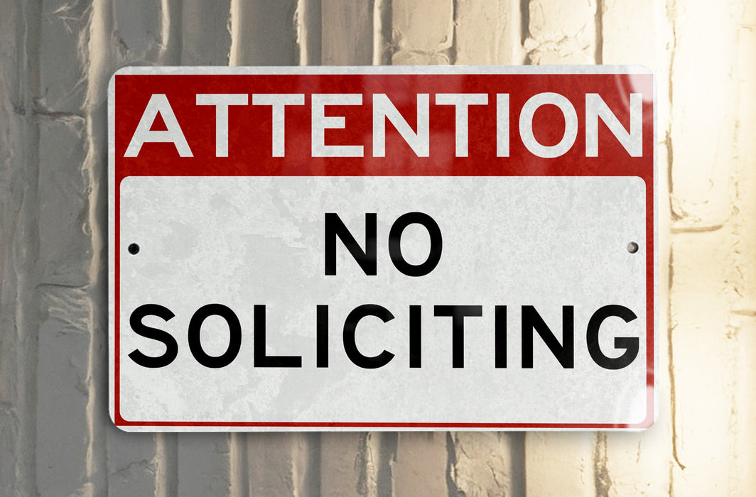 a red and white street sign that says no parking