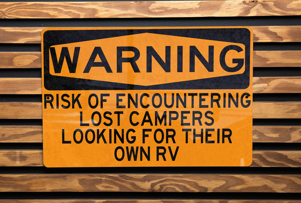 a yellow and black sign on a wooden wall