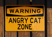 a yellow sign on a wooden fence that says something